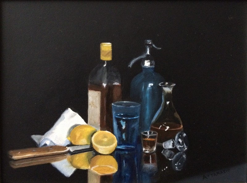 Still life with bottles and sliced lemon on glass table